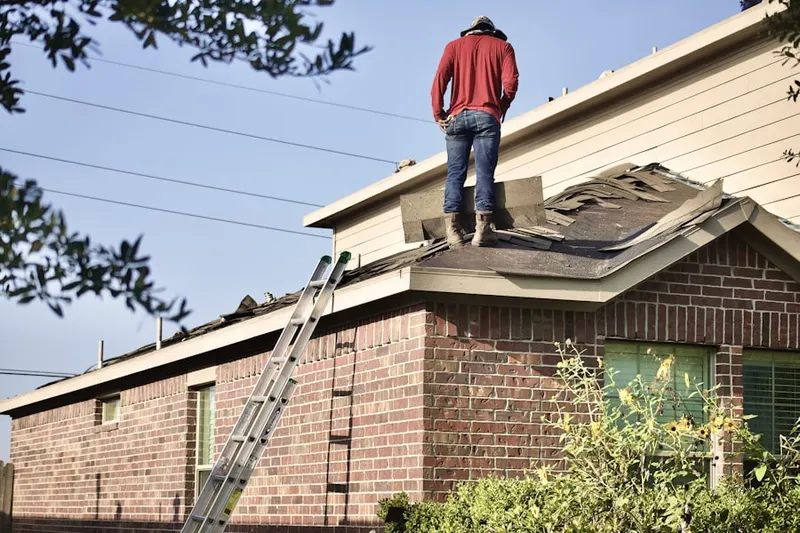 Professional roofer working on a residential roof in Onondaga